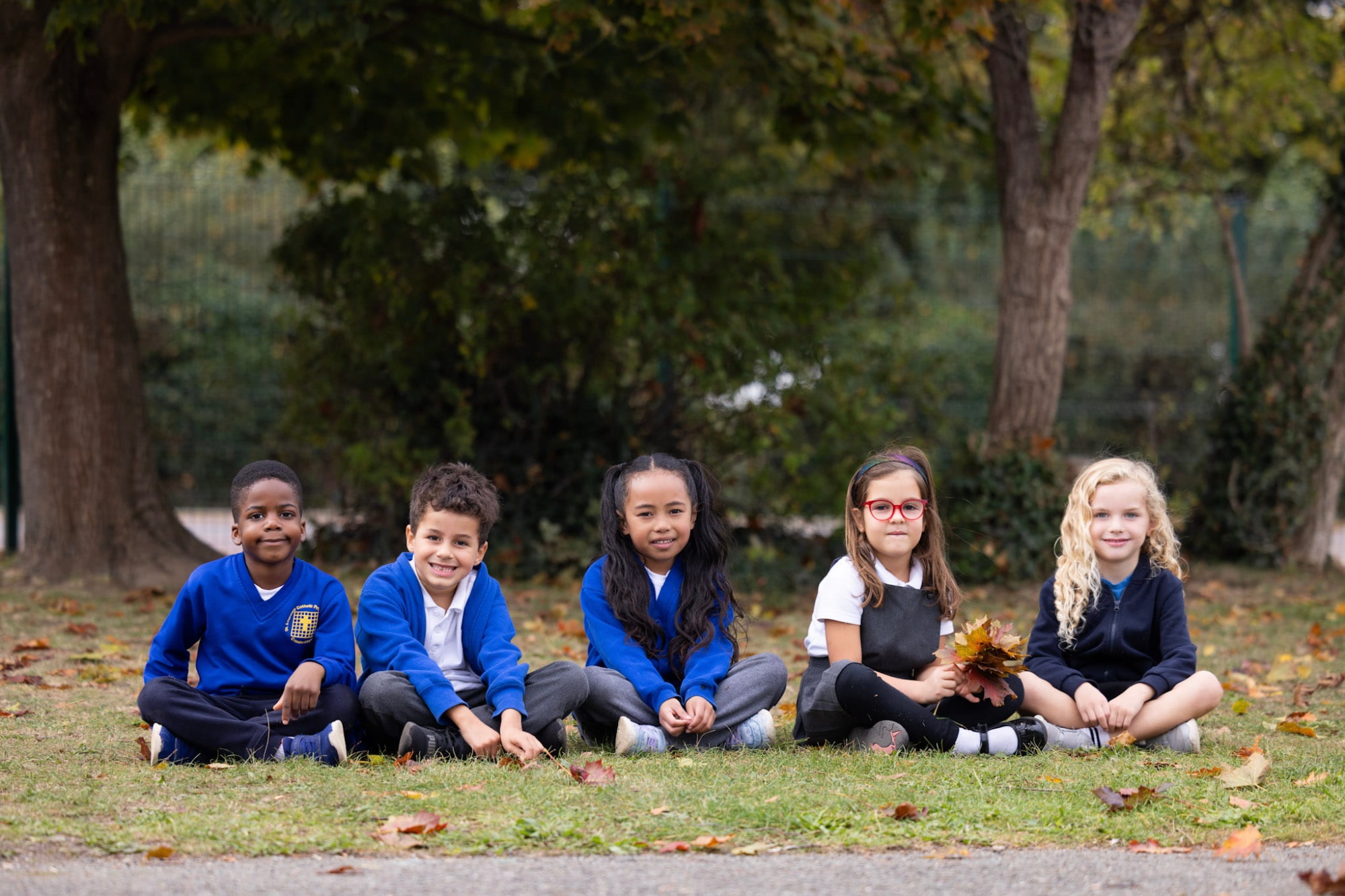 KS1 pupils sitting on the grass